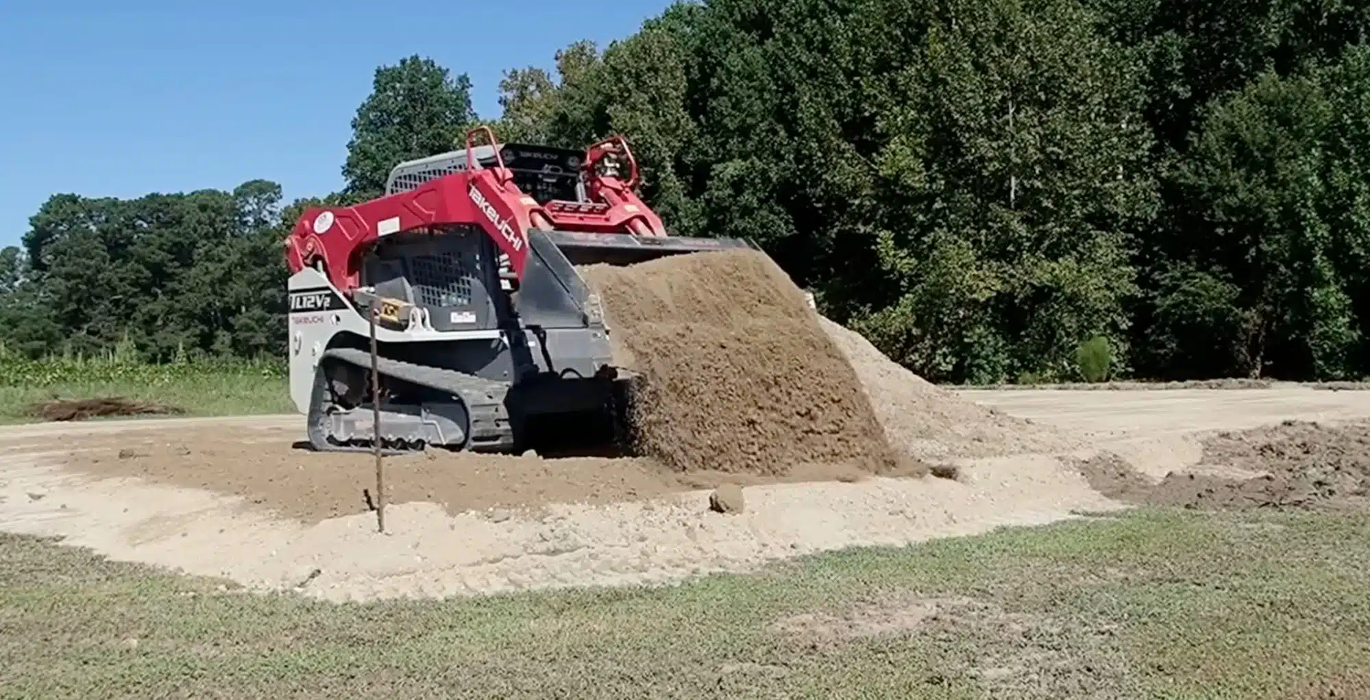 Dump truck delivering fill dirt for site leveling